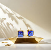 Stylish 10mm Asscher cut Blue Sapphire studs in yellow gold plating.